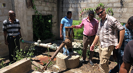 working on a water pump in Haiti