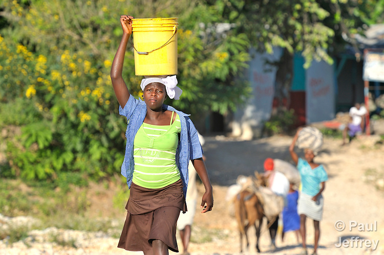 Woman carring water bucket on her head